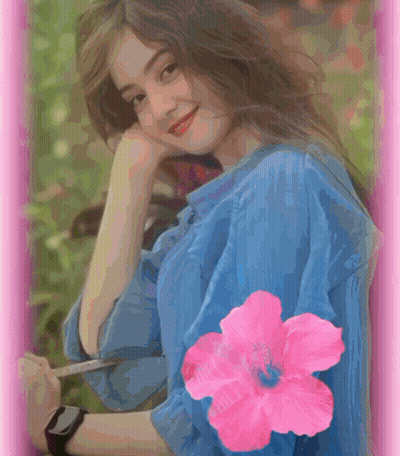 A Woman In A Blue Shirt Has A Pink Flower On Her Sleeve GIF