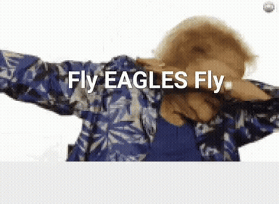 A Woman In A Blue Shirt Is Dancing And Says Fly Eagles Fly GIF