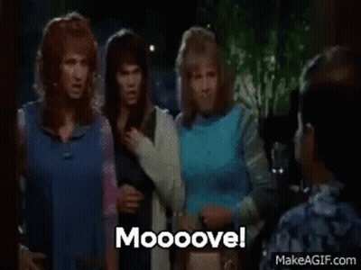 A Woman In A Blue Shirt Is Dancing With A Man In A Blue Shirt In A Club . GIF