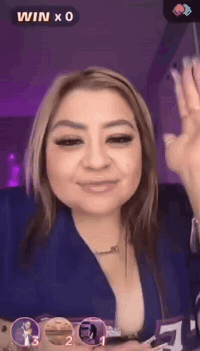 A Woman In A Blue Shirt Is Giving A Thumbs Up Sign GIF