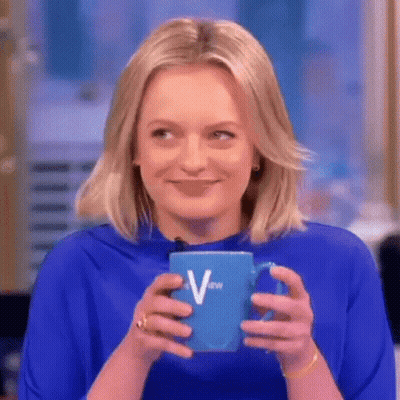A Woman In A Blue Shirt Is Holding A Blue Cup Of Coffee . GIF