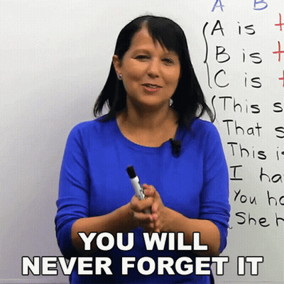 A Woman In A Blue Shirt Is Holding A Marker In Front Of A White Board That Says You Will Never Forget It GIF