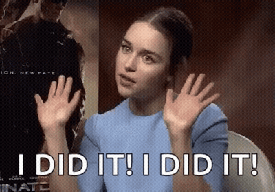 A Woman In A Blue Shirt Is Sitting In A Chair With Her Hands Up And Says `` I Did It ! '' GIF