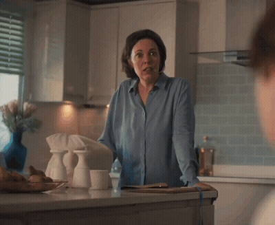 A Woman In A Blue Shirt Is Standing In A Kitchen With The Words " Uh ... Not Following " Below Her GIF