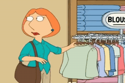 A Woman In A Blue Shirt Is Standing In Front Of A Sign That Says Blouses GIF