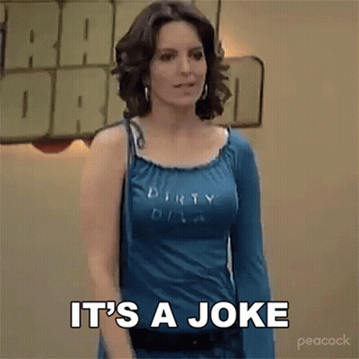 A Woman In A Blue Shirt Is Standing In Front Of A Sign That Says It 'S A Joke . GIF
