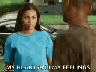 A Woman In A Blue Shirt Is Standing Next To A Man In A Brown Shirt And Saying `` My Heart And My Feelings '' . GIF