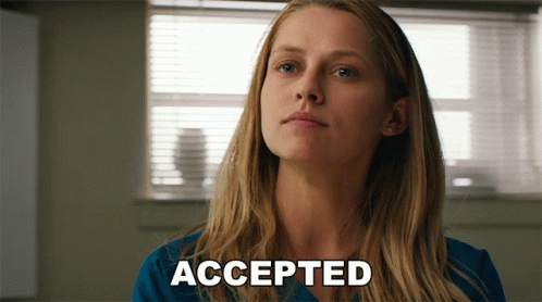 A Woman In A Blue Shirt Says Accepted In Front Of A Window GIF