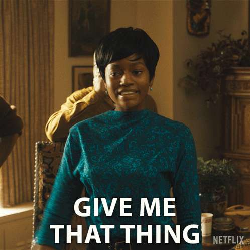 A Woman In A Blue Shirt Says Give Me That Thing On A Netflix Ad GIF