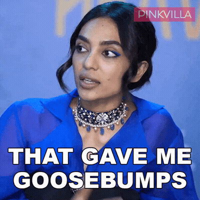 A Woman In A Blue Shirt Says That Gave Me Goosebumps In White Letters GIF