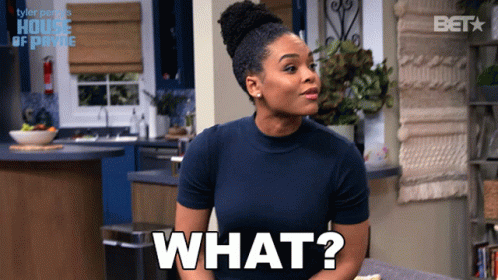 A Woman In A Blue Shirt Says What In A Kitchen GIF