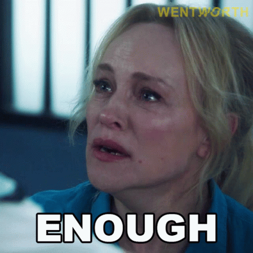 A Woman In A Blue Shirt With The Word Enough Written On It GIF