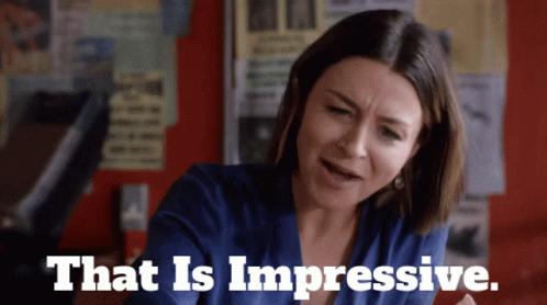 A Woman In A Blue Shirt With The Words That Is Impressive GIF