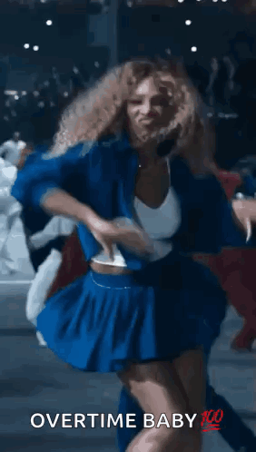 A Woman In A Blue Skirt Is Dancing With The Words Overtime Baby 100 Written On The Bottom . GIF