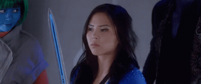 A Woman In A Blue Suit Is Sitting In Front Of A Group Of People And Says Fight . GIF