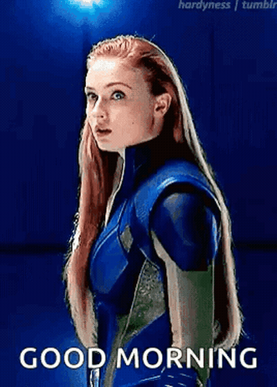 A Woman In A Blue Suit Is Standing In Front Of A Blue Background With The Words `` Good Morning '' . GIF