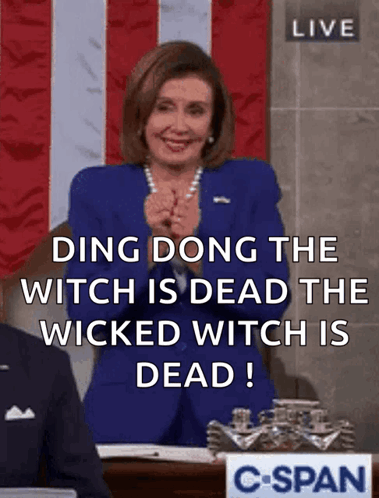 A Woman In A Blue Suit Says Ding Dong The Witch Is Dead GIF
