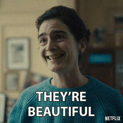 A Woman In A Blue Sweater Is Smiling With The Words They 'Re Beautiful Below Her GIF