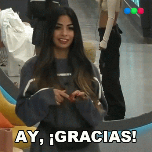 A Woman In A Blue Sweater Says Ay Gracias In Spanish GIF