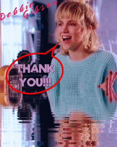 A Woman In A Blue Sweater Says " Thank You " GIF