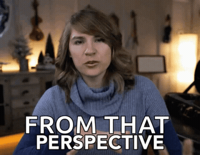 A Woman In A Blue Sweater With The Words From That Perspective On Her Face GIF