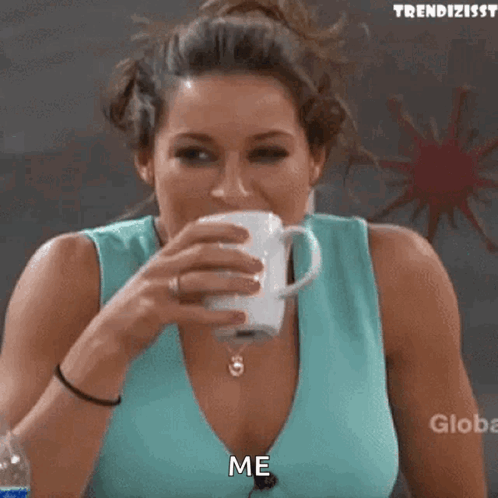 A Woman In A Blue Tank Top Is Drinking From A Cup And Says Me GIF