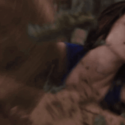A Woman In A Blue Tank Top Is Laying Down With Her Eyes Closed GIF