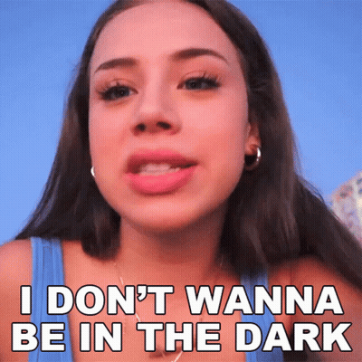 A Woman In A Blue Tank Top Says I Don 'T Wanna Be In The Dark GIF