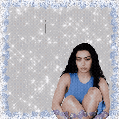 A Woman In A Blue Tank Top Sits On The Floor With The Words I Have Above Her GIF