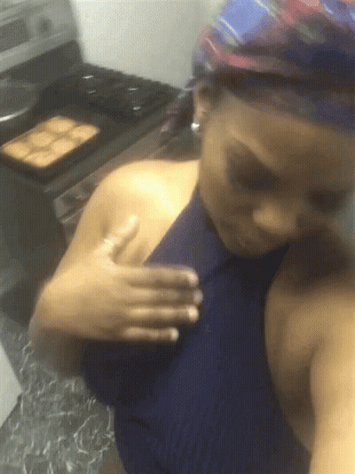 A Woman In A Blue Top Is Taking A Selfie GIF