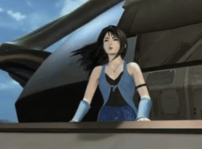 A Woman In A Blue Vest And Blue Gloves Stands In Front Of A Building GIF