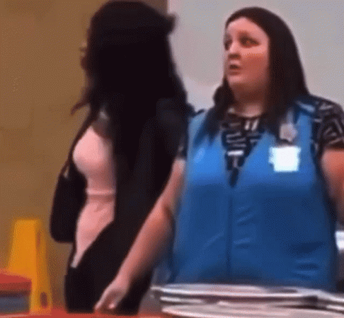 A Woman In A Blue Vest Is Standing Next To A Woman In A Pink Dress . GIF
