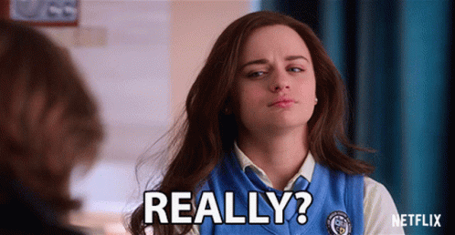 A Woman In A Blue Vest Says " Really " In Front Of A Man GIF
