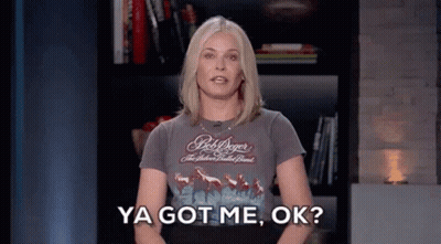 A Woman In A Bob Dylan Shirt Is Standing In Front Of A Bookshelf And Saying Ya Got Me , Ok . GIF
