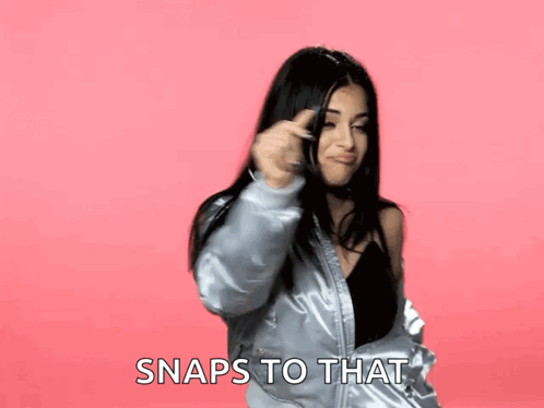 A Woman In A Bomber Jacket Says Snaps To That In A Pink Background GIF