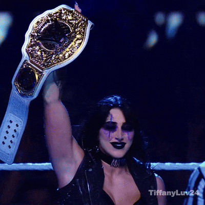 A Woman In A Boxing Ring Holding A Championship Belt With Tiffanyluv24 Written On The Bottom Right GIF