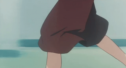 A Woman In A Brown Skirt And White Shoes Is Standing On A Green Floor GIF
