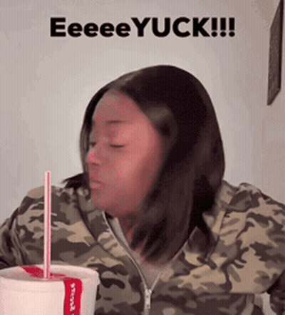 A Woman In A Camo Jacket Drinking From A Cup With A Straw And The Words Eeeeyuck GIF
