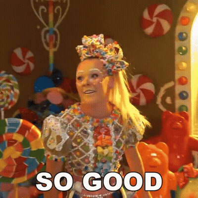 A Woman In A Candy Costume Says So Good In Front Of Candy GIF