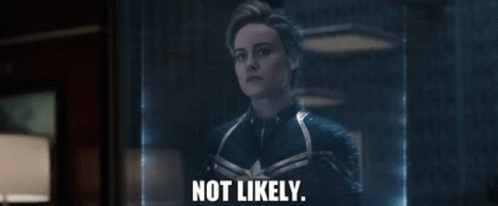 A Woman In A Captain Marvel Suit Is Standing In Front Of A Glass Wall And Says `` Not Likely '' . GIF