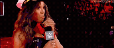 A Woman In A Captain 'S Hat Is Holding A Microphone In Front Of A Crowd . GIF