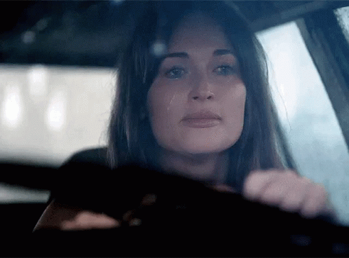 A Woman In A Car With A Tear Running Down Her Cheek GIF