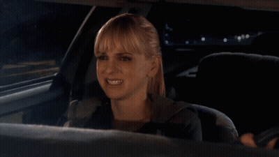 A Woman In A Car With Okay Well Written On The Bottom GIF