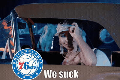 a woman in a car with the philadelphia 76ers logo