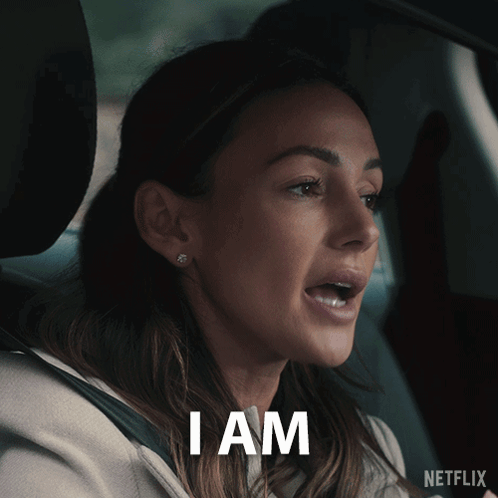 A Woman In A Car With The Word I Am Written On Her Face GIF