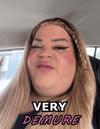 A Woman In A Car With The Words Very Demure Written On Her Face GIF
