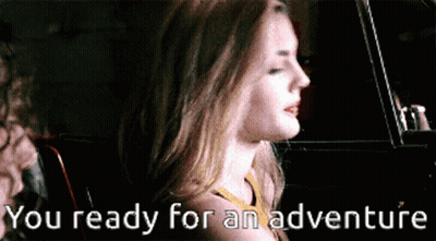 A Woman In A Car With The Words You Ready For An Adventure Written Below Her GIF