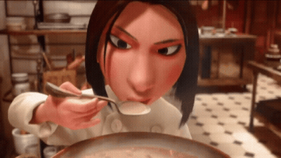 A Woman In A Chef 'S Uniform Is Eating Soup With A Spoon GIF