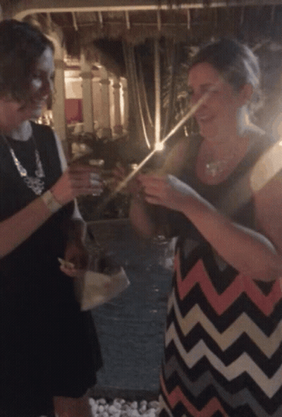 A Woman In A Chevron Dress Is Holding A Straw GIF