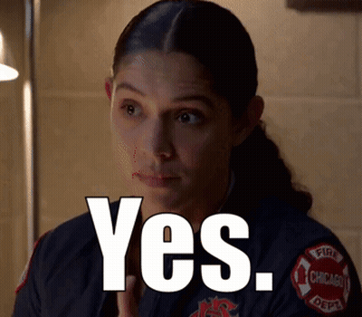 A Woman In A Chicago Fire Department Uniform Is Saying Yes GIF